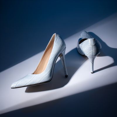 Pale blue stiletto pumps in raking studio light, photo by Jose Martin Segura Benites on Pexels