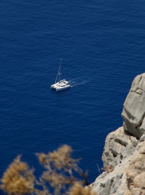 Free A serene view of a sailboat gliding through the clear blue sea near Fethiye. Stock Photo