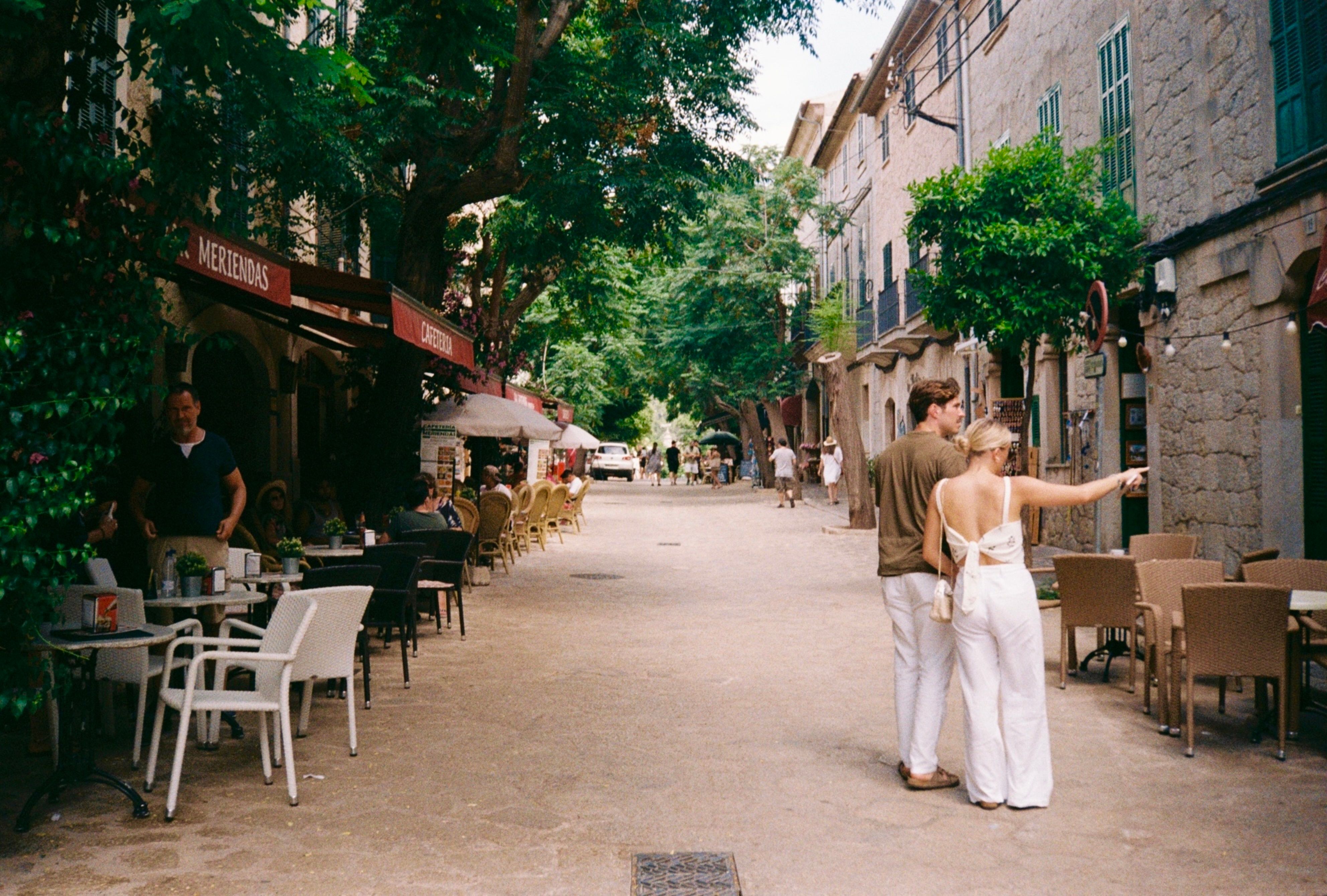 Couple strolling along a picturesque street in Palma de Mallorca, Spain.