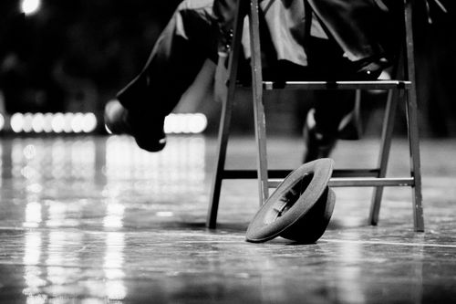 Free Artistic black and white photo capturing a hat on reflective surface with chair detail. Stock Photo