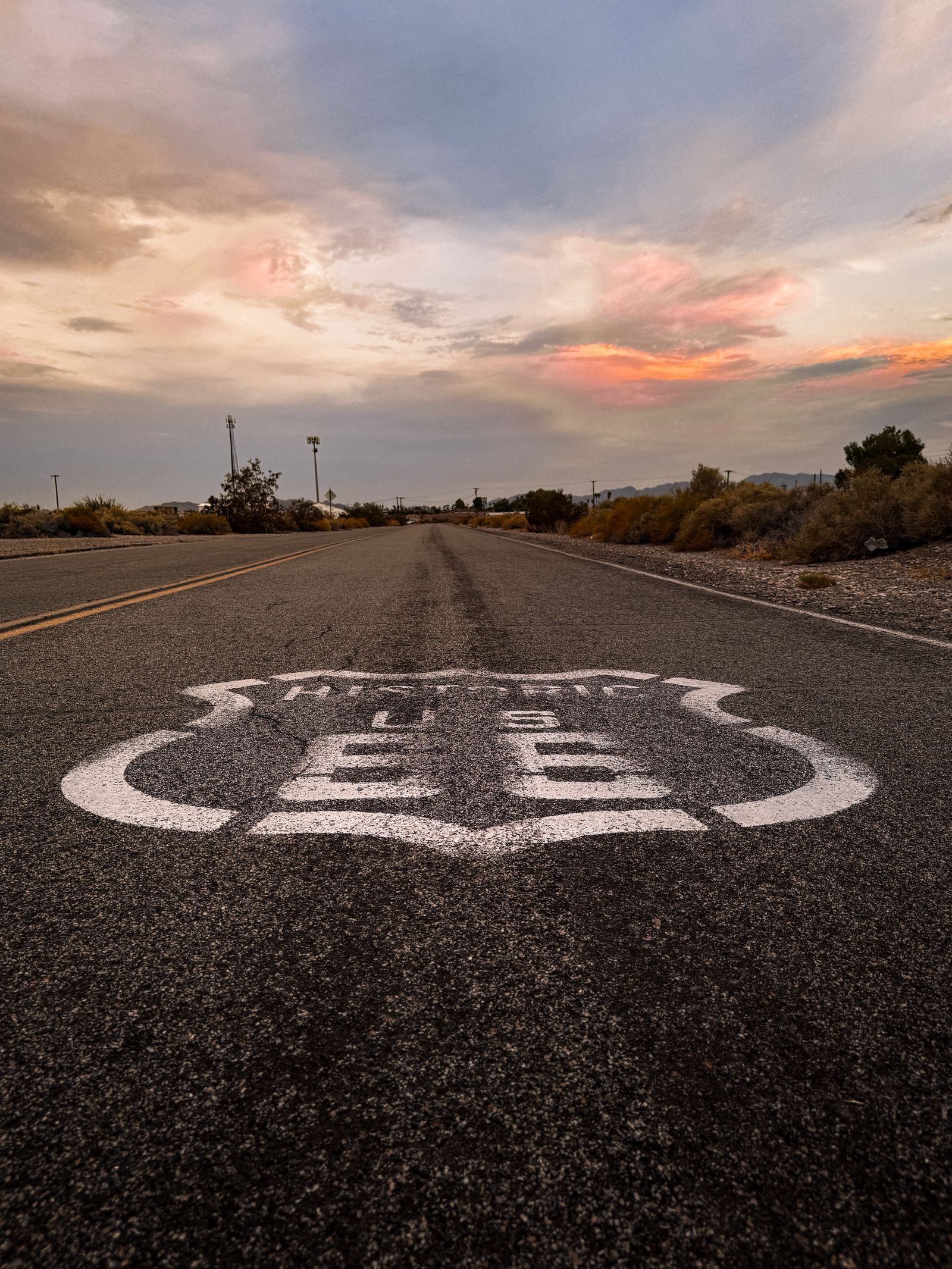 Historic Route 66 sign on an open road at sunset, the kind of Mother Road stop that still defines an Oklahoma City evening