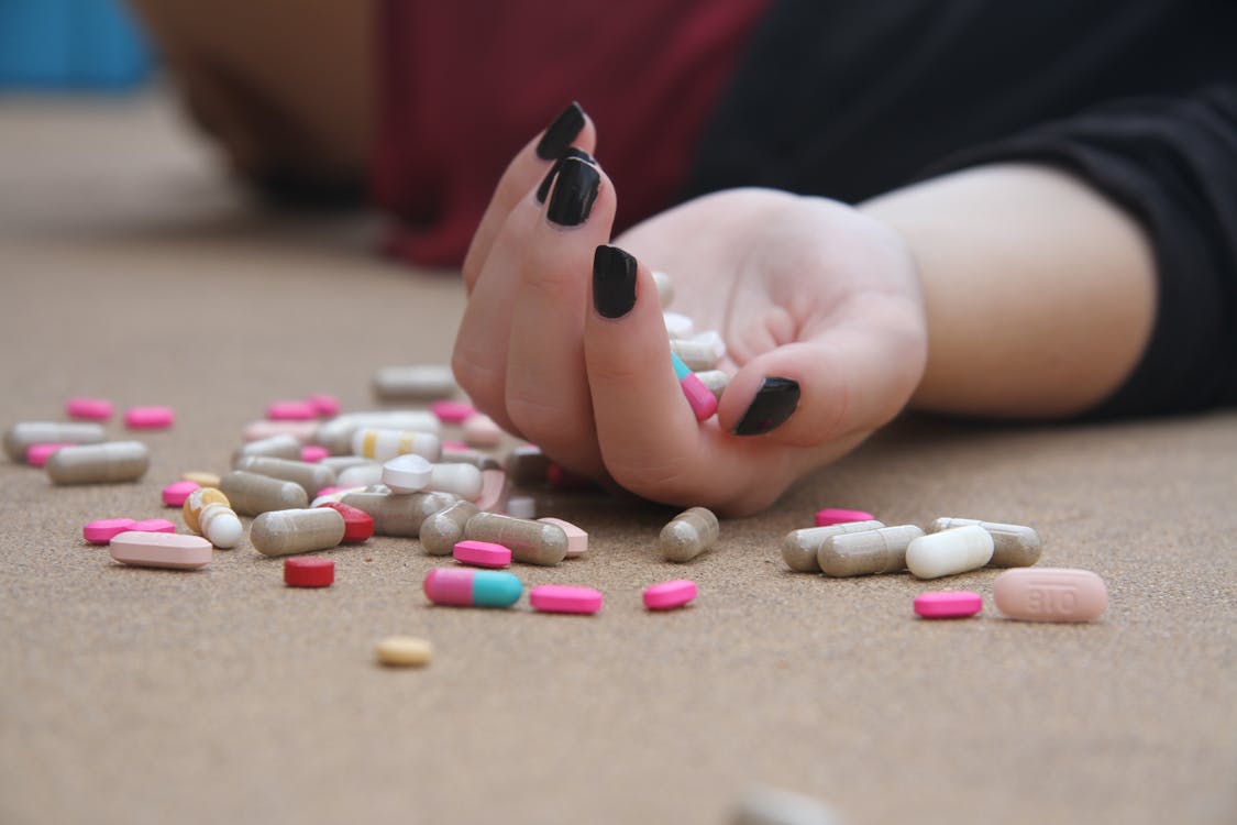 Person Holding Medical Pills