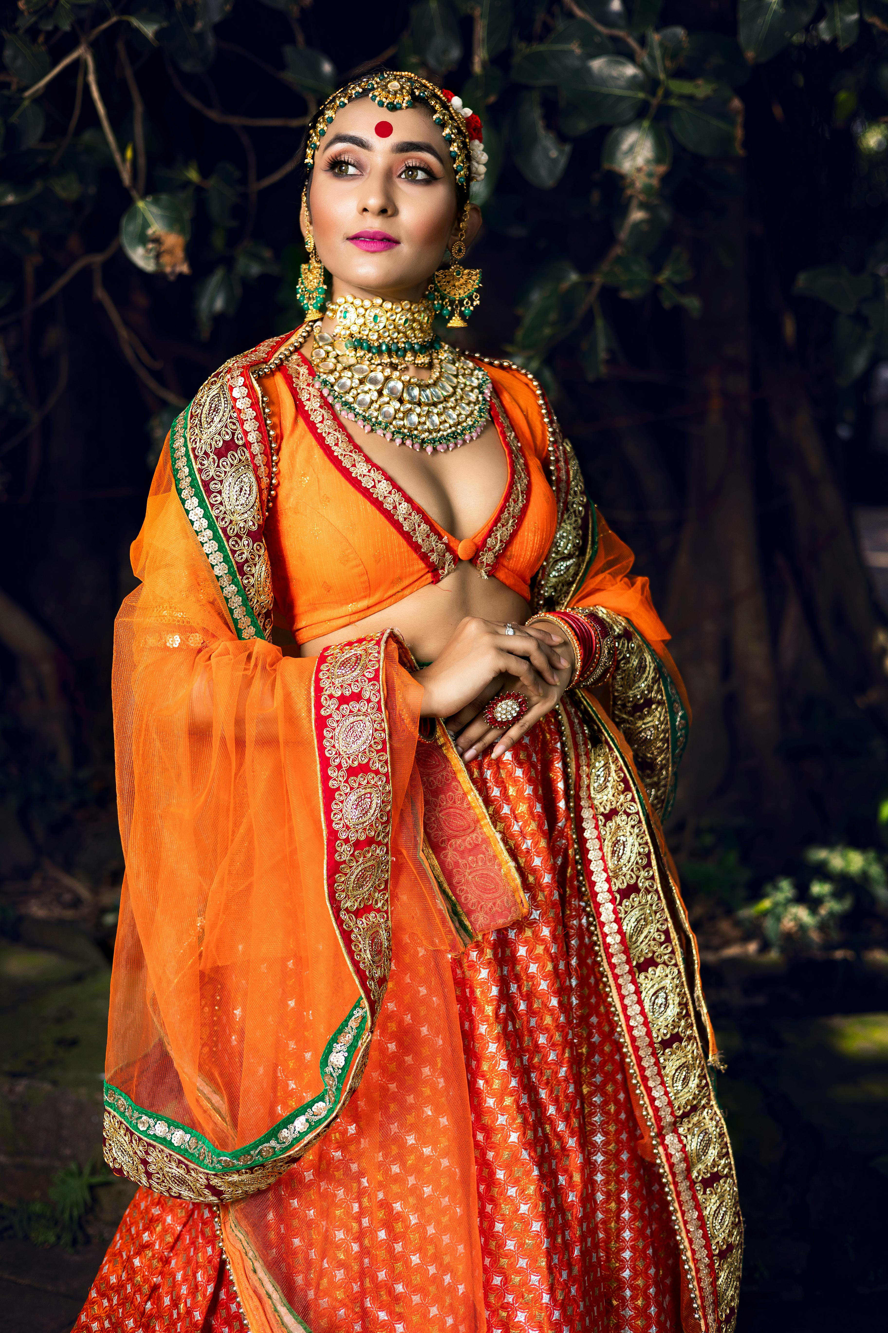 ethenic fashion photoshoot of a young girl in orange creative light