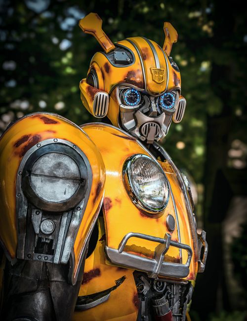 Free A detailed portrait of a futuristic yellow robot with intricate design features, displayed outdoors. Stock Photo