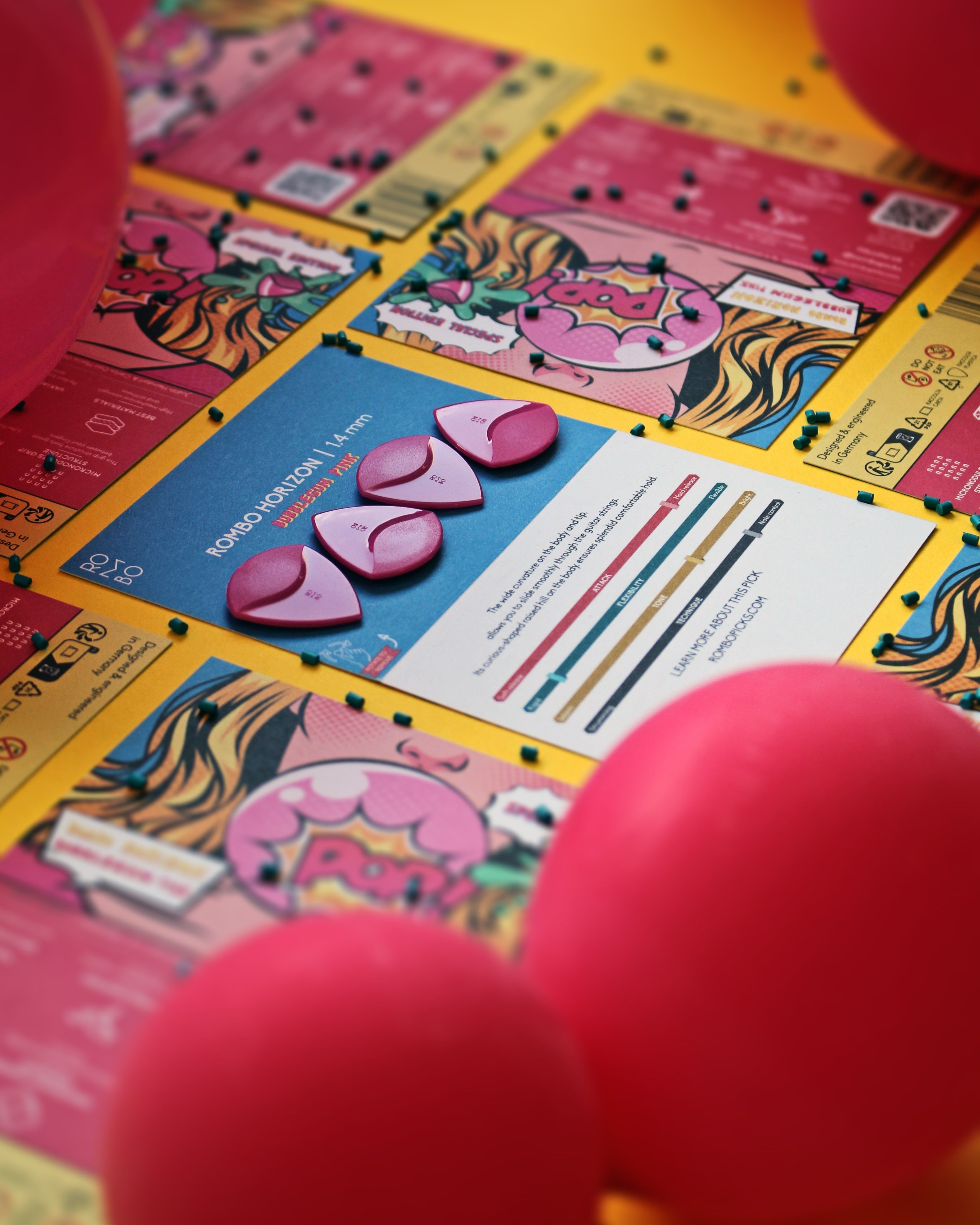 Vibrant pink guitar picks displayed on pop art-themed posters for creative backgrounds.