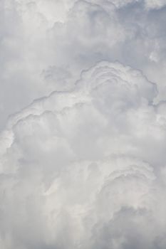 A beautiful, dense formation of cumulus clouds fills the sky, showcasing nature's majestic weather patterns.