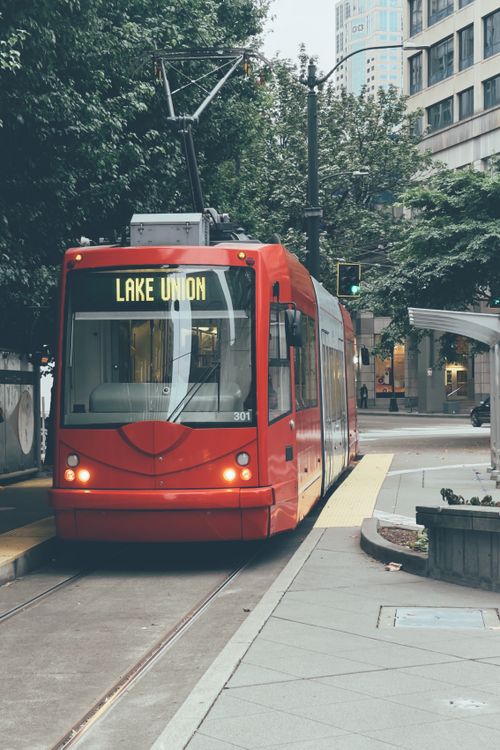 Free Red streetcar labeled Lake Union in downtown Seattle, showcasing urban public transport. Stock Photo