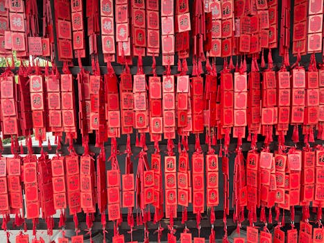 A colorful display of traditional red hanging tags used for wishes in Asian cultures.
