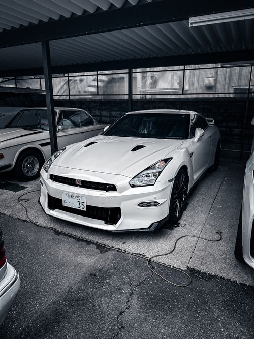 Free White Nissan GT-R parked under covered area in Kyoto, Japan. Stock Photo