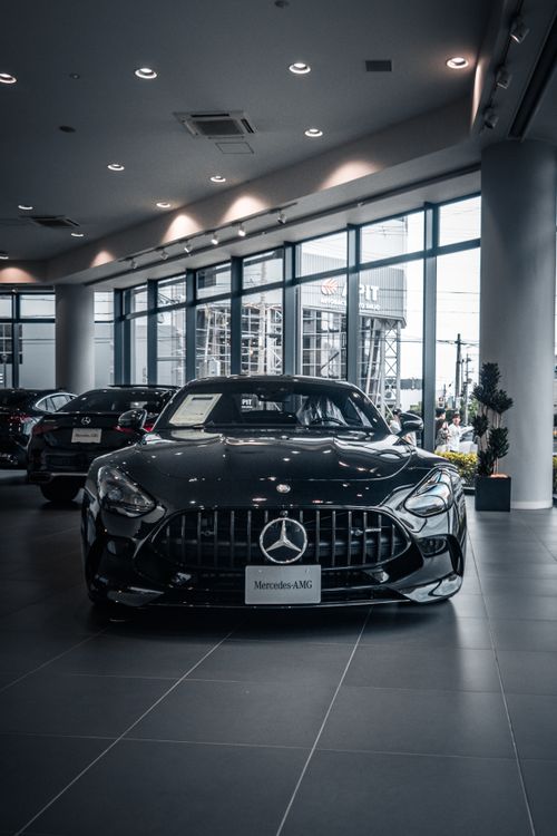 Free A sleek Mercedes-AMG showcased in a modern Kyoto showroom, highlighting luxury and automotive design. Stock Photo