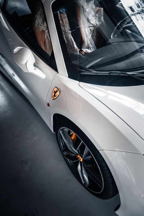 Free Elegant white sports car with sleek design and luxurious logo captured in Kyoto, Japan. Stock Photo