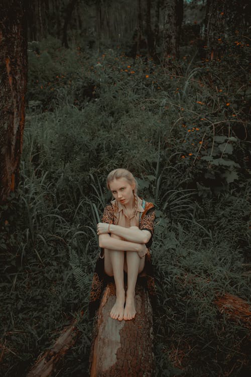 Free Woman Sitting On A Log Stock Photo