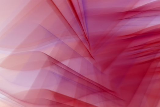 Colorful abstract art with red and pink geometric shapes creating a vivid, futuristic background.