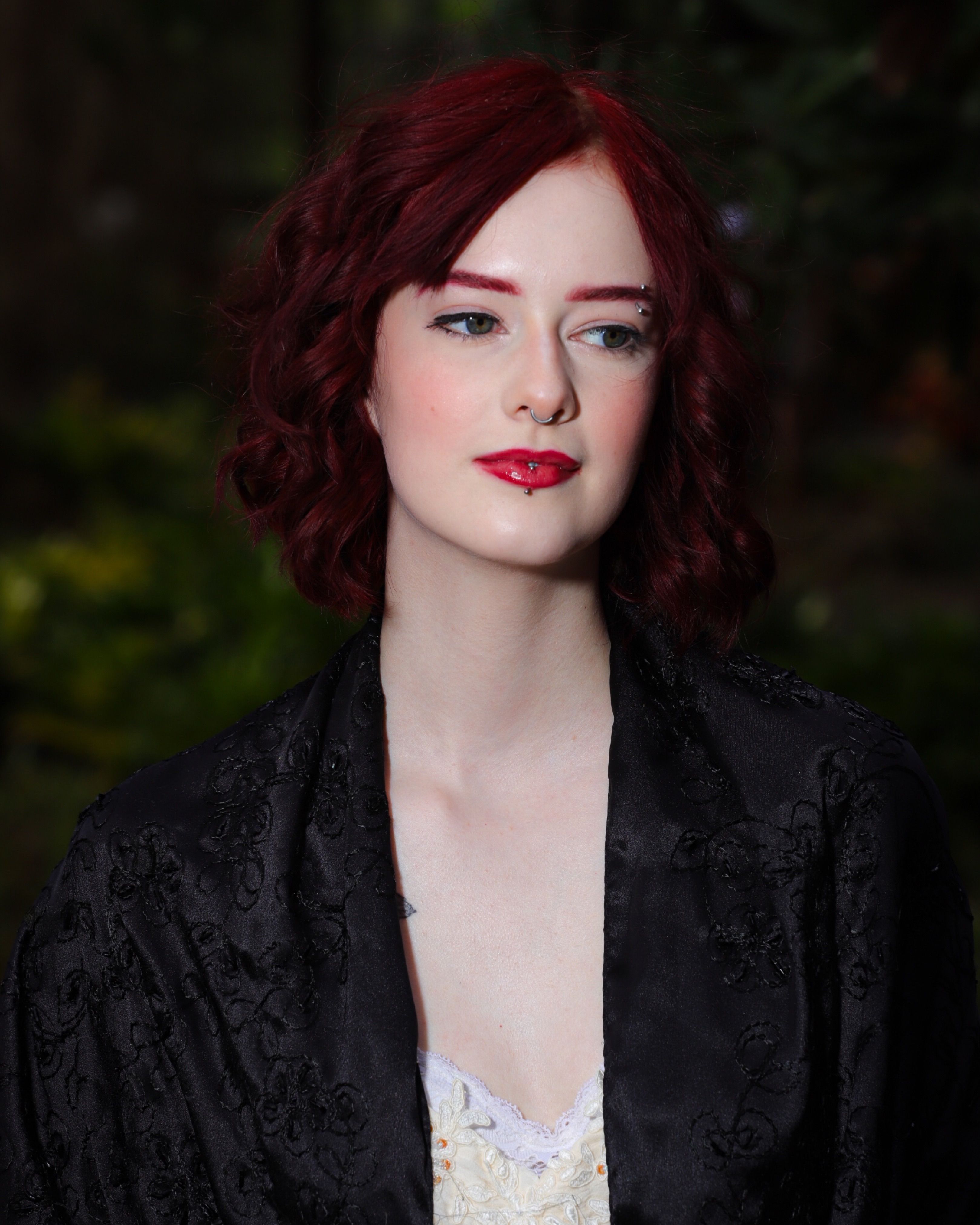 Elegant Portrait of a Woman with Red Hair Outdoors · Free Stock Photo