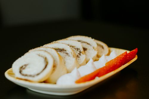Free Indulgent Swiss roll slices with fresh strawberries and cream on a stylish plate. Stock Photo