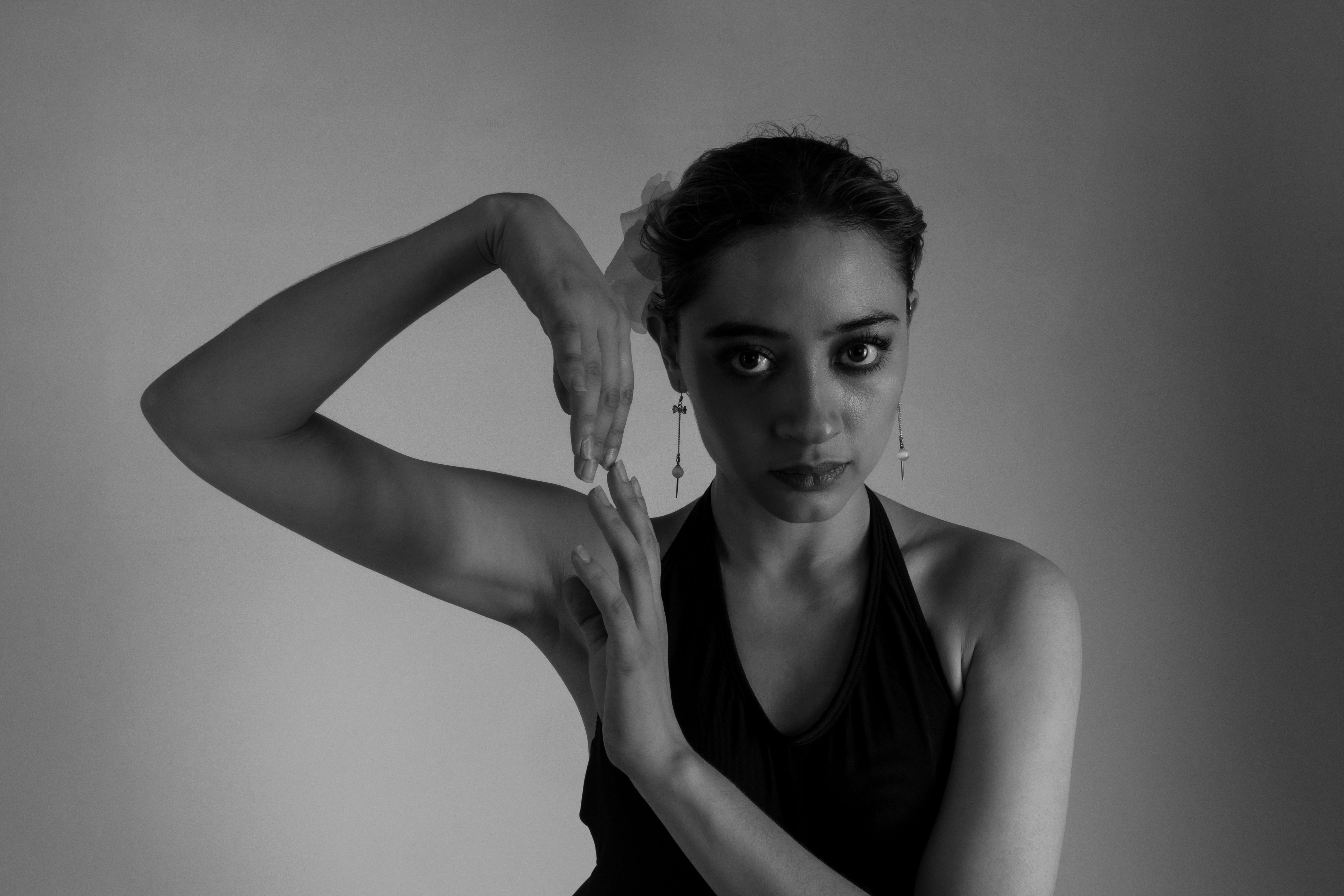 A woman in black and white posing with her hands · Free Stock Photo
