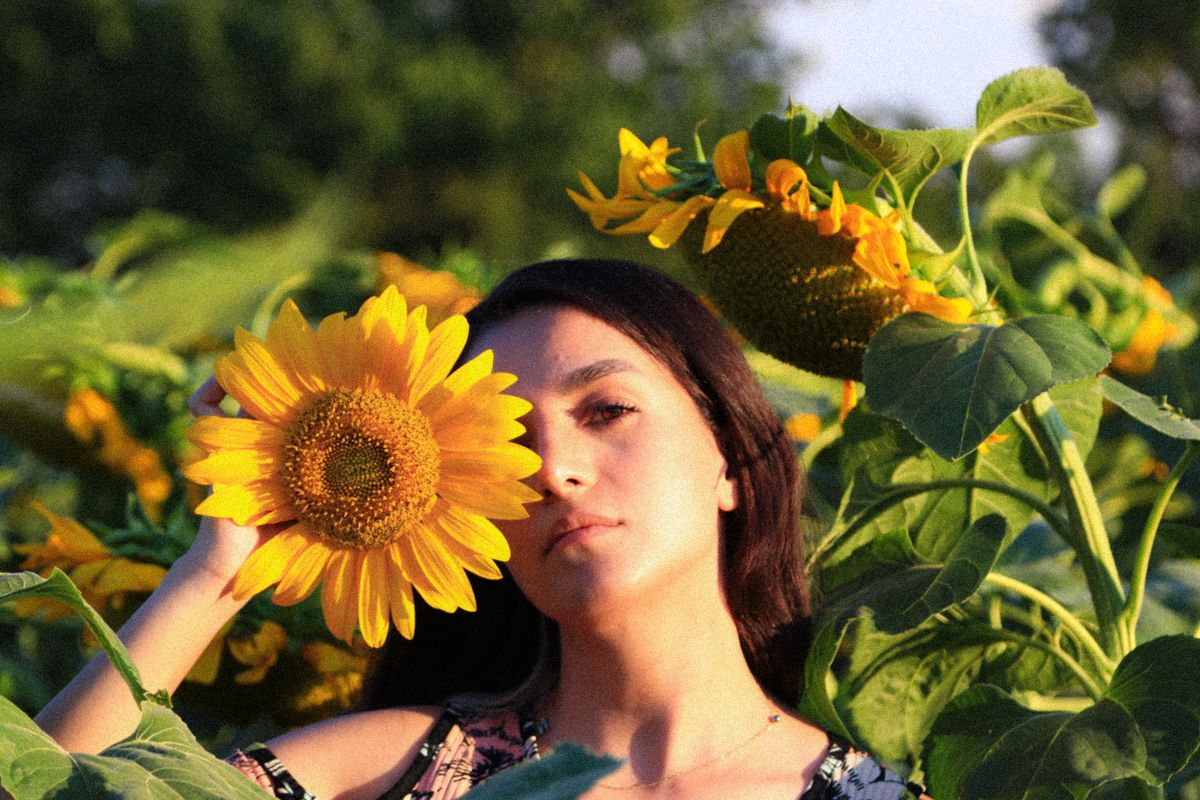 Woman Standing in the Middle of Sunflower Field · Free Stock Photo