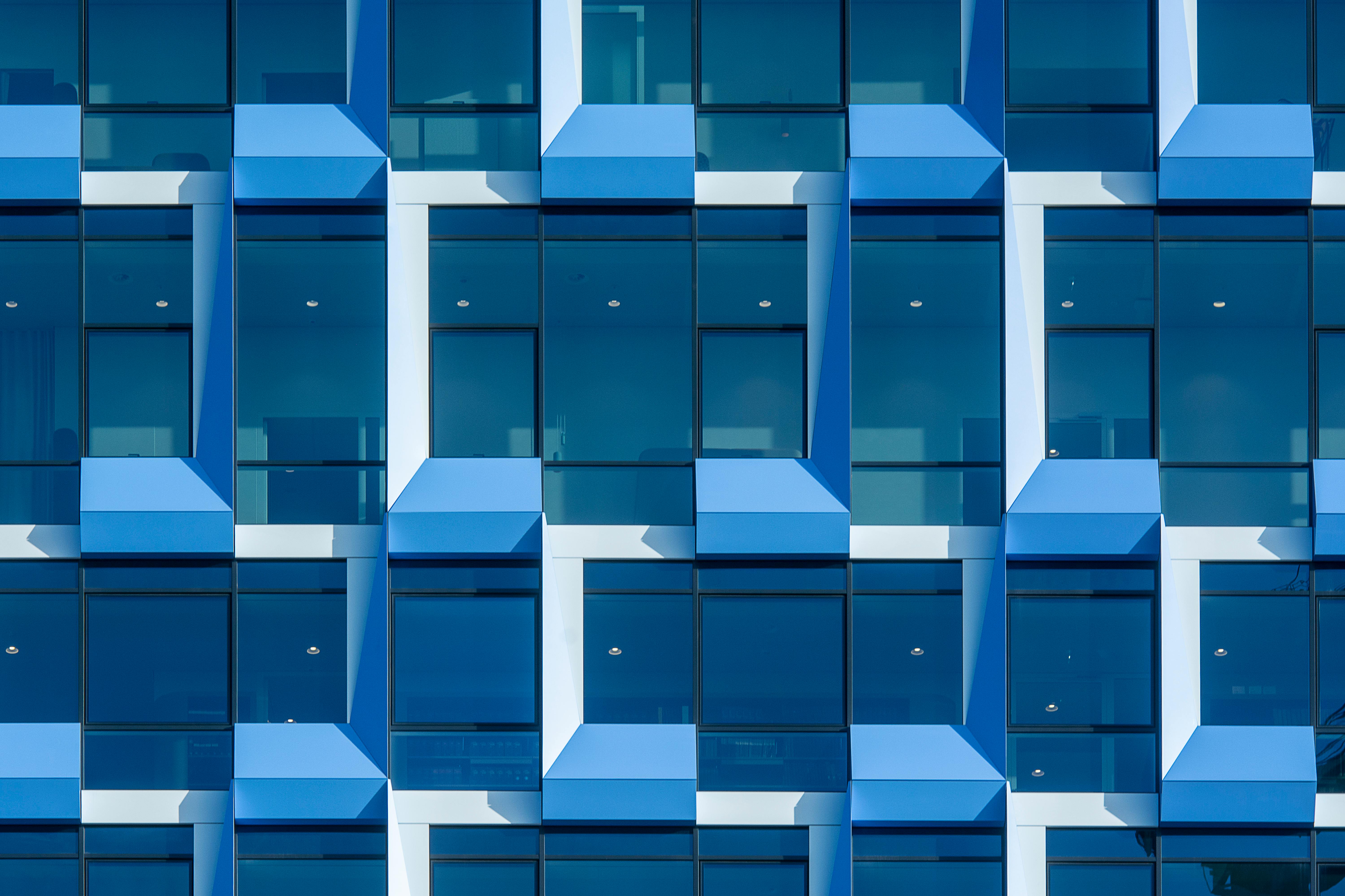 a close up of a blue building with white windows