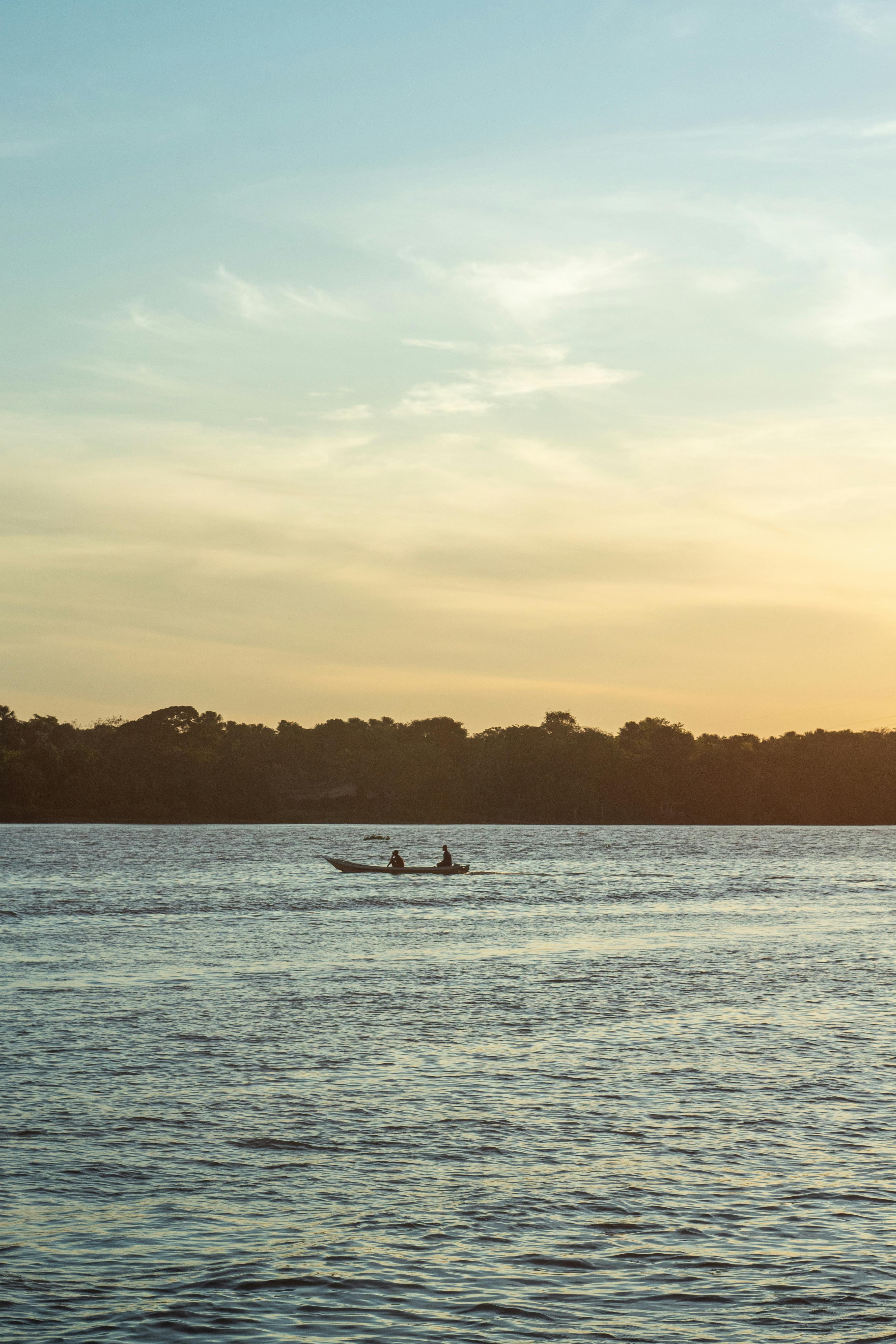 view of a boat on a body of water at sunset