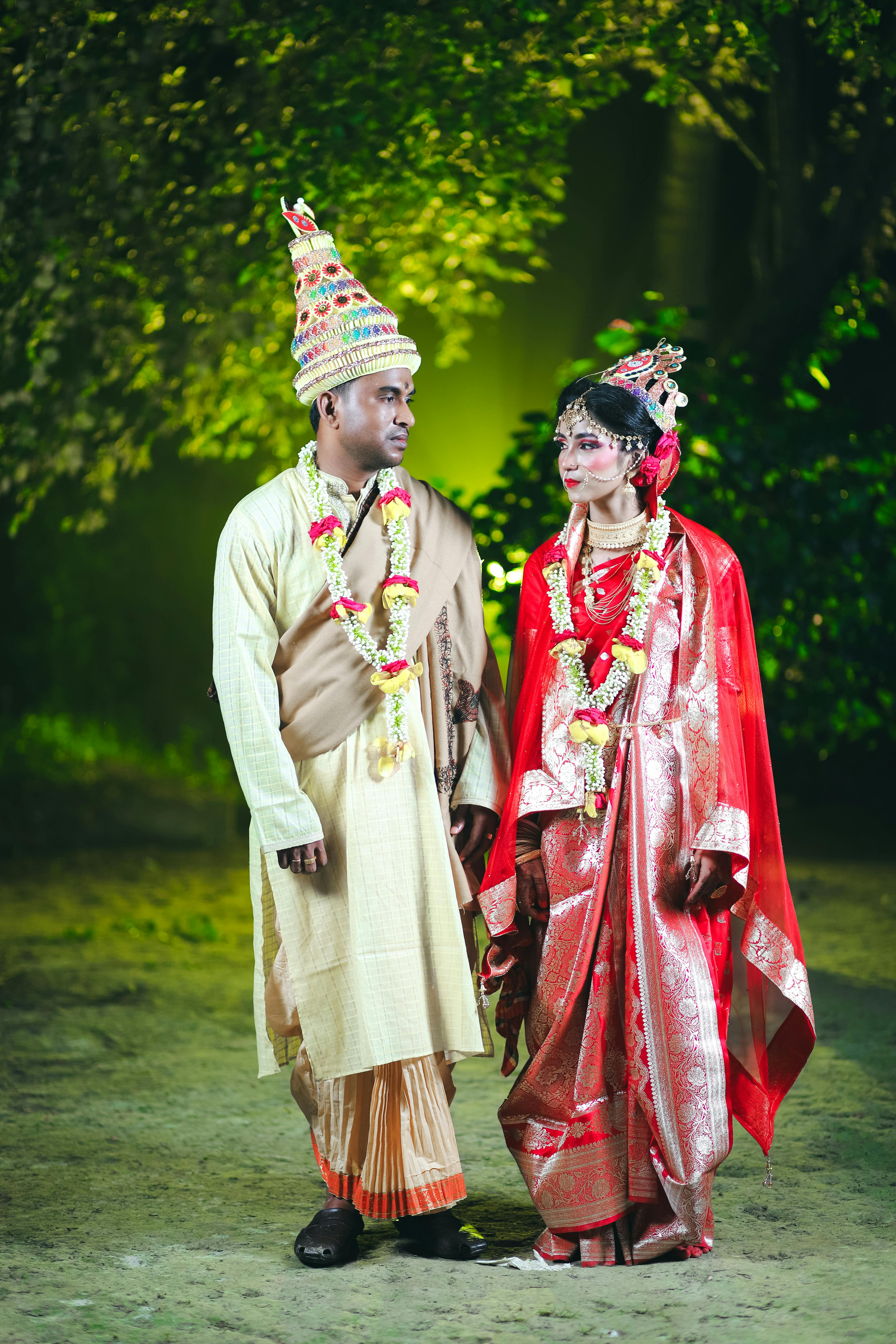 newlywed couple standing in traditional clothing