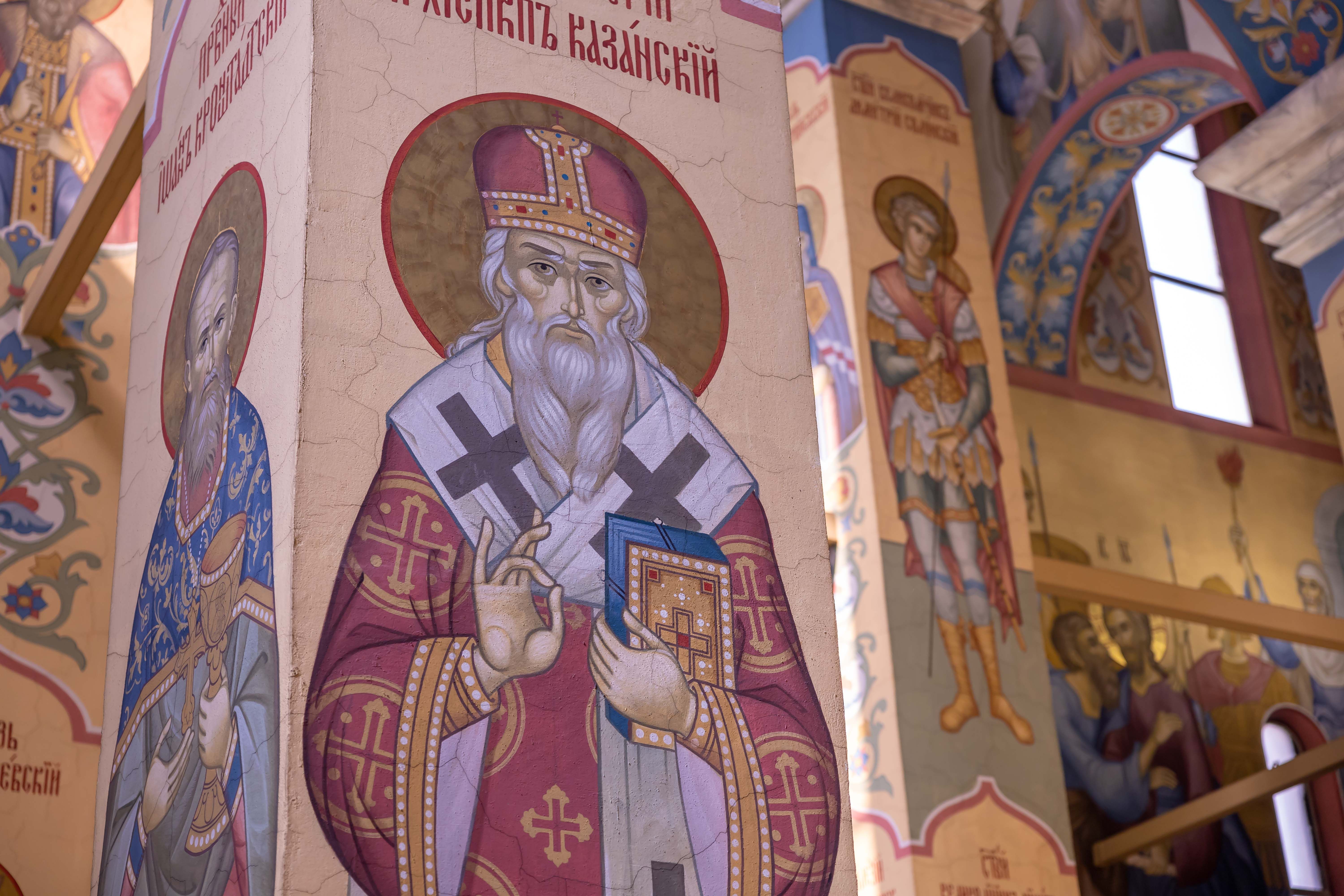 Vibrant mosaics depicting saints and religious figures inside an ornate church.