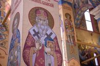 Vibrant mosaics depicting saints and religious figures inside an ornate church.