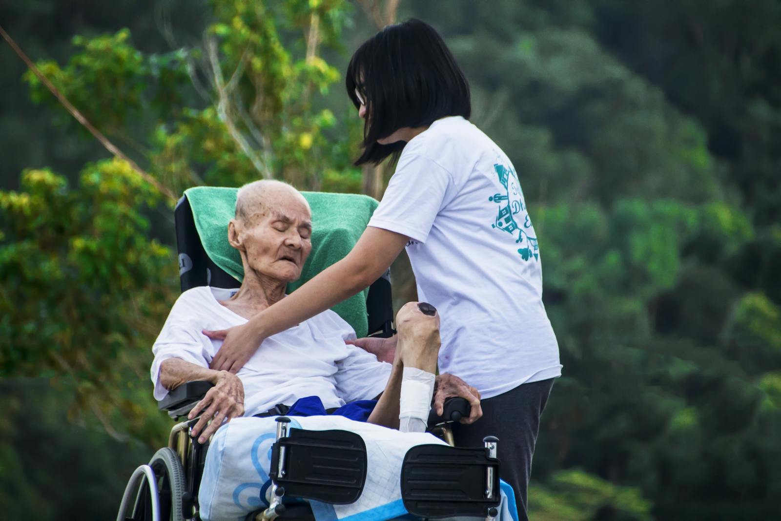 Asian caregiver with elderly resident