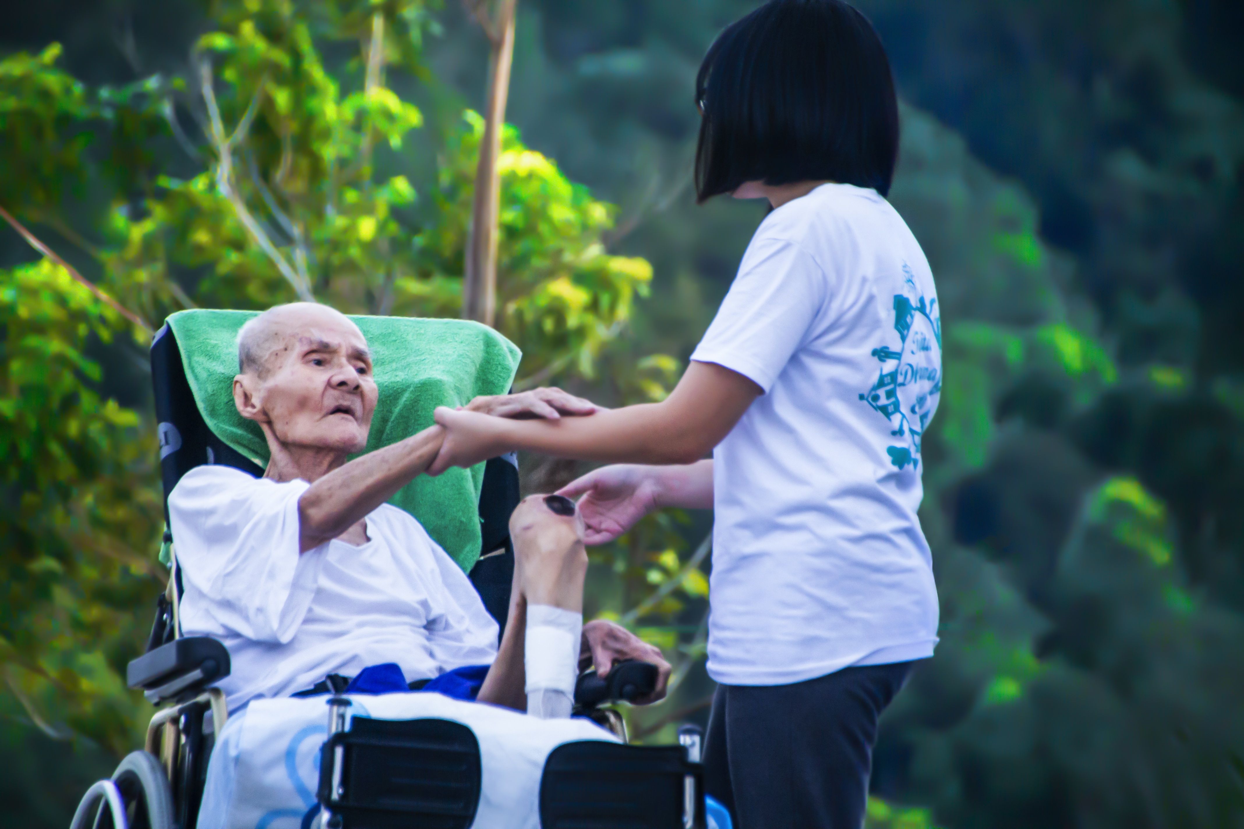 A home-health worker assisting a patient at home