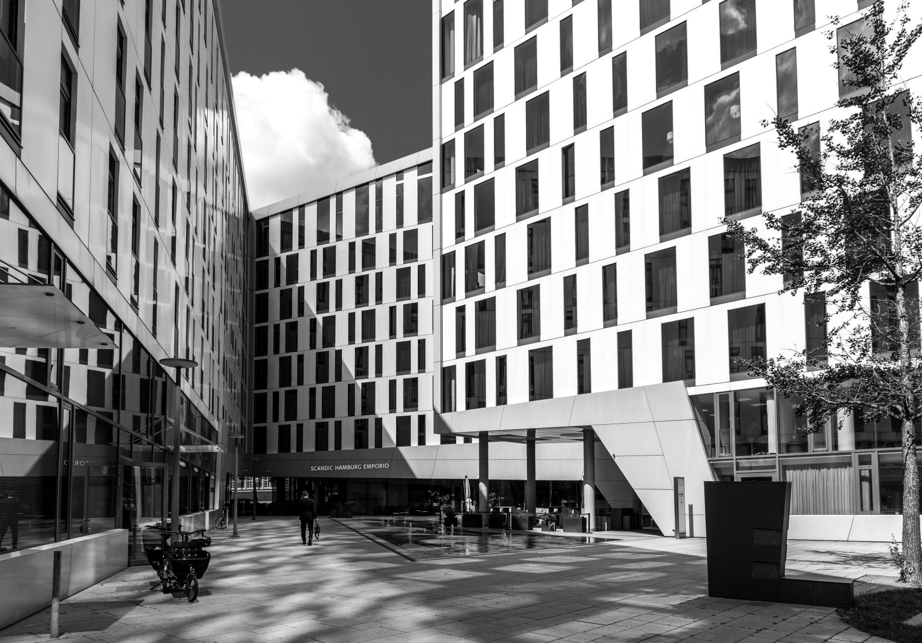 Black and white shot of modern buildings in Hamburg, showcasing sleek architectural design and reflections.