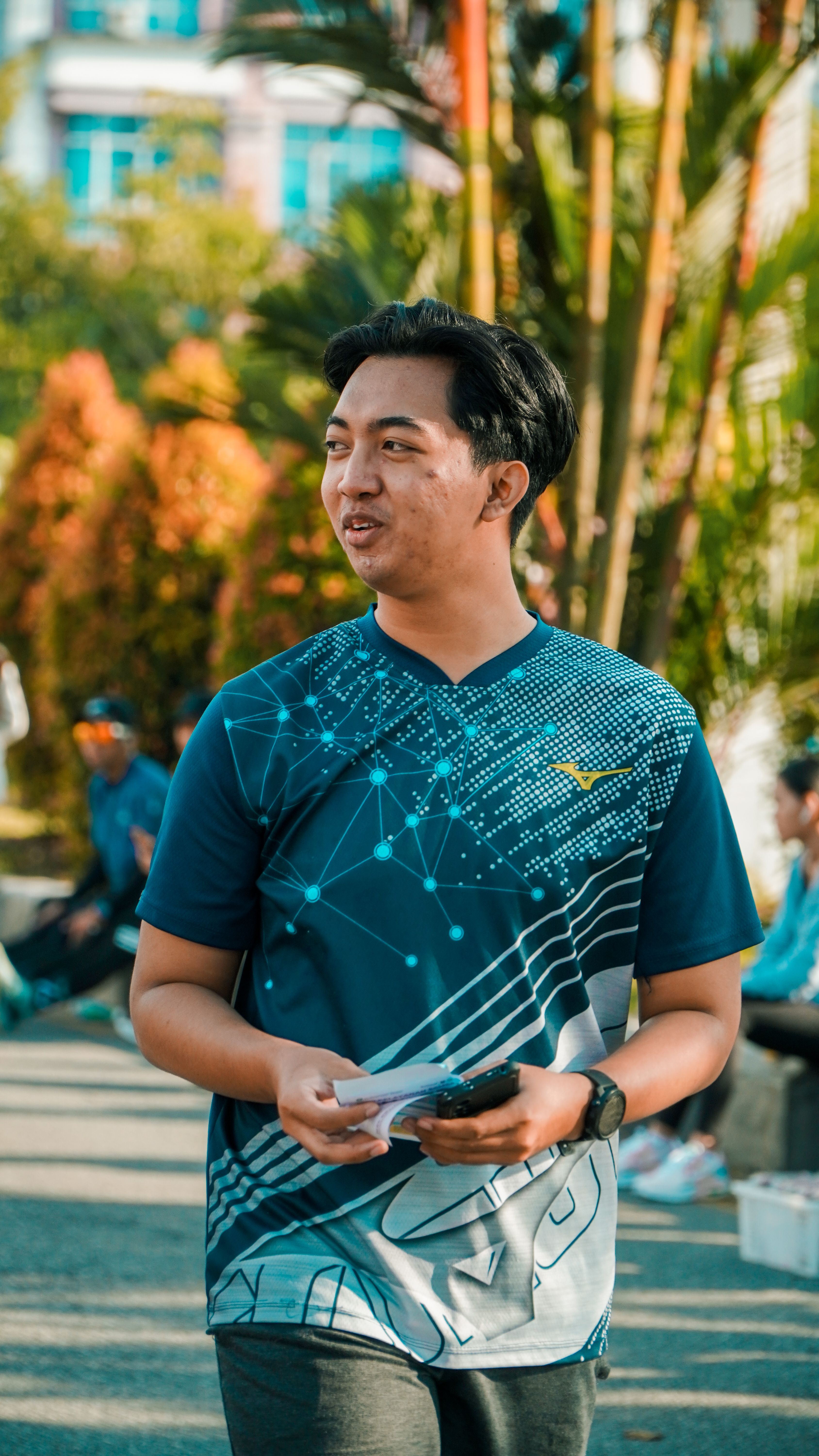Casual portrait of a smiling young man enjoying a sunny day outdoors in Pontianak, Indonesia.