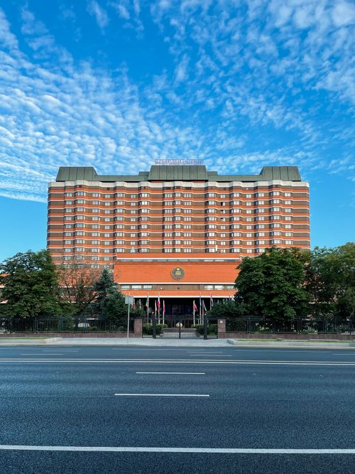 Free Front view of a modern hotel in Moscow, showcasing contemporary architecture against a clear sky. Stock Photo