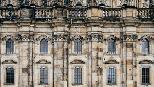 Free Close-up view of a gothic-style historic castle facade showcasing intricate stone architecture. Stock Photo