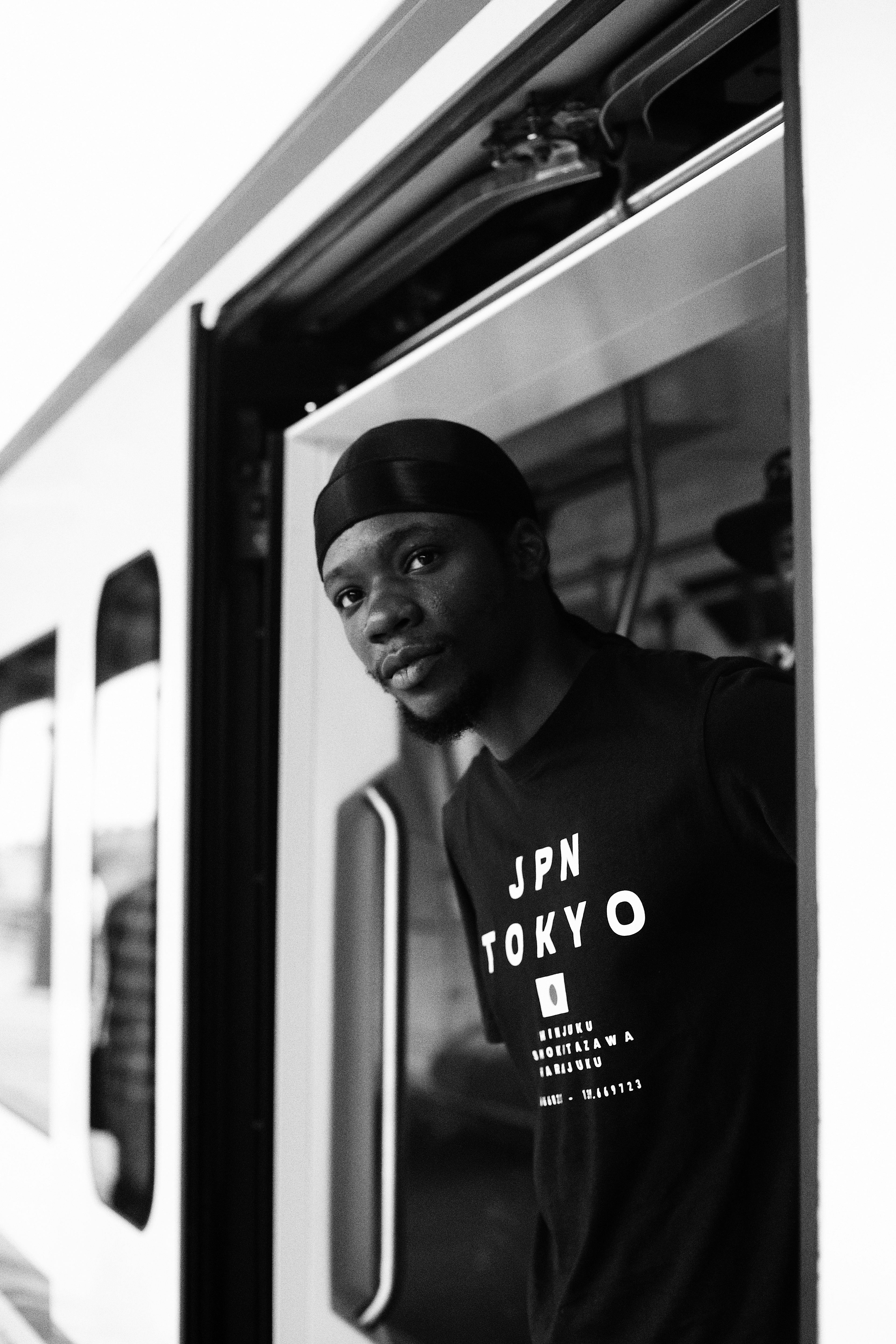 black and white shot of a man getting off a subway train