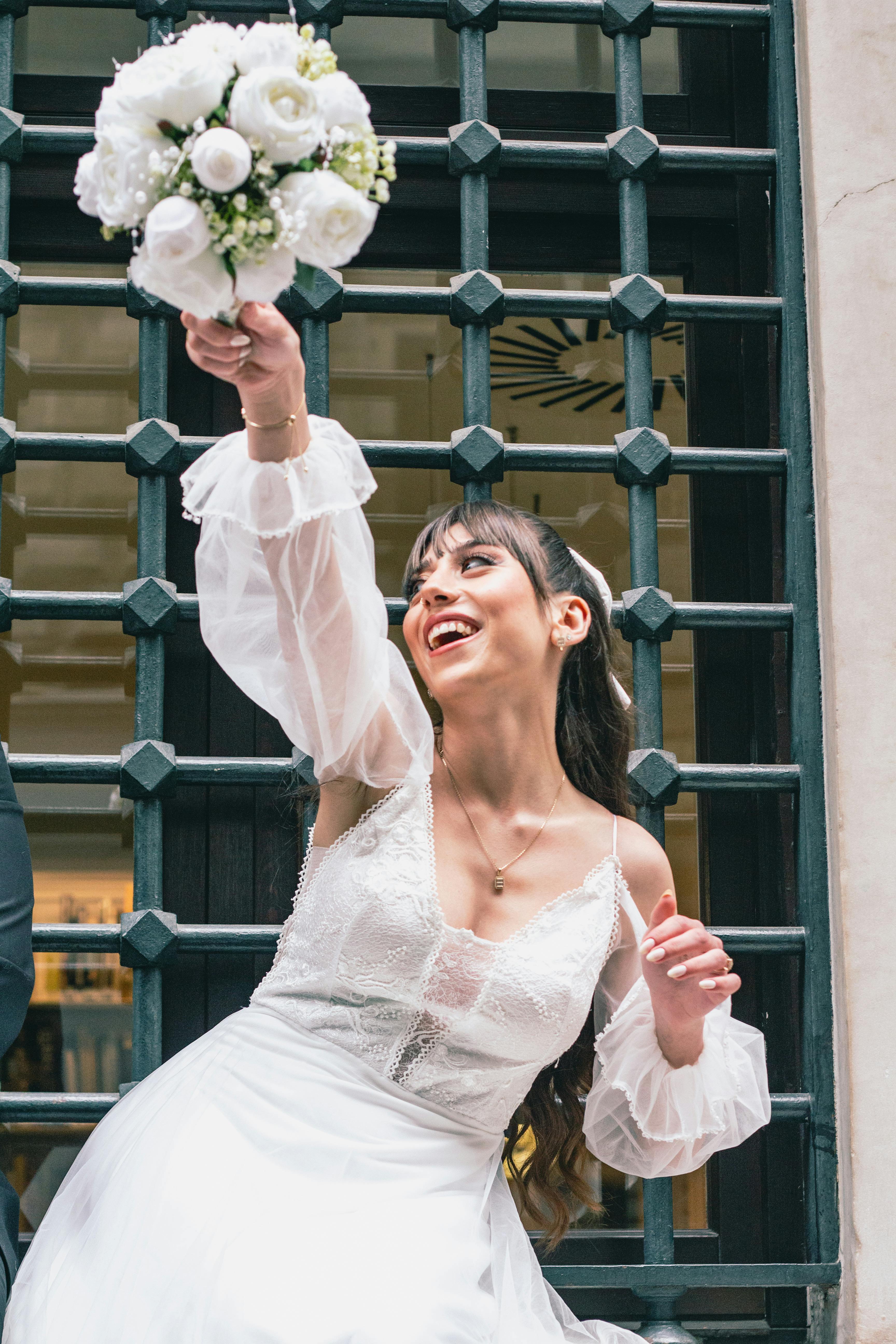 a bride is holding her bouquet in her hand