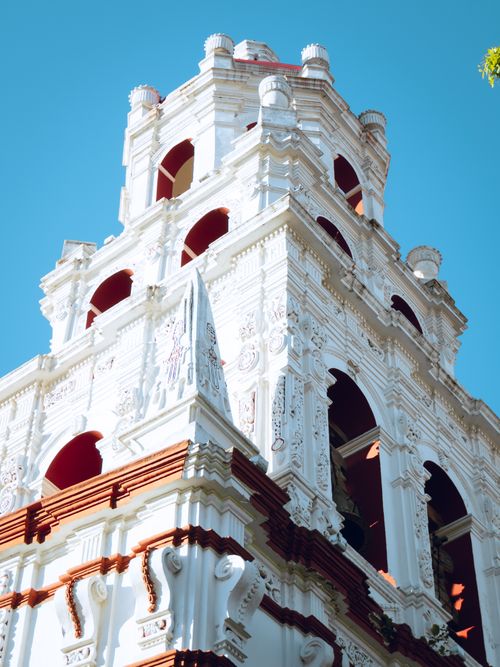 Free Beautiful white stone bell tower showcasing traditional Mexican architecture against a clear sky. Stock Photo