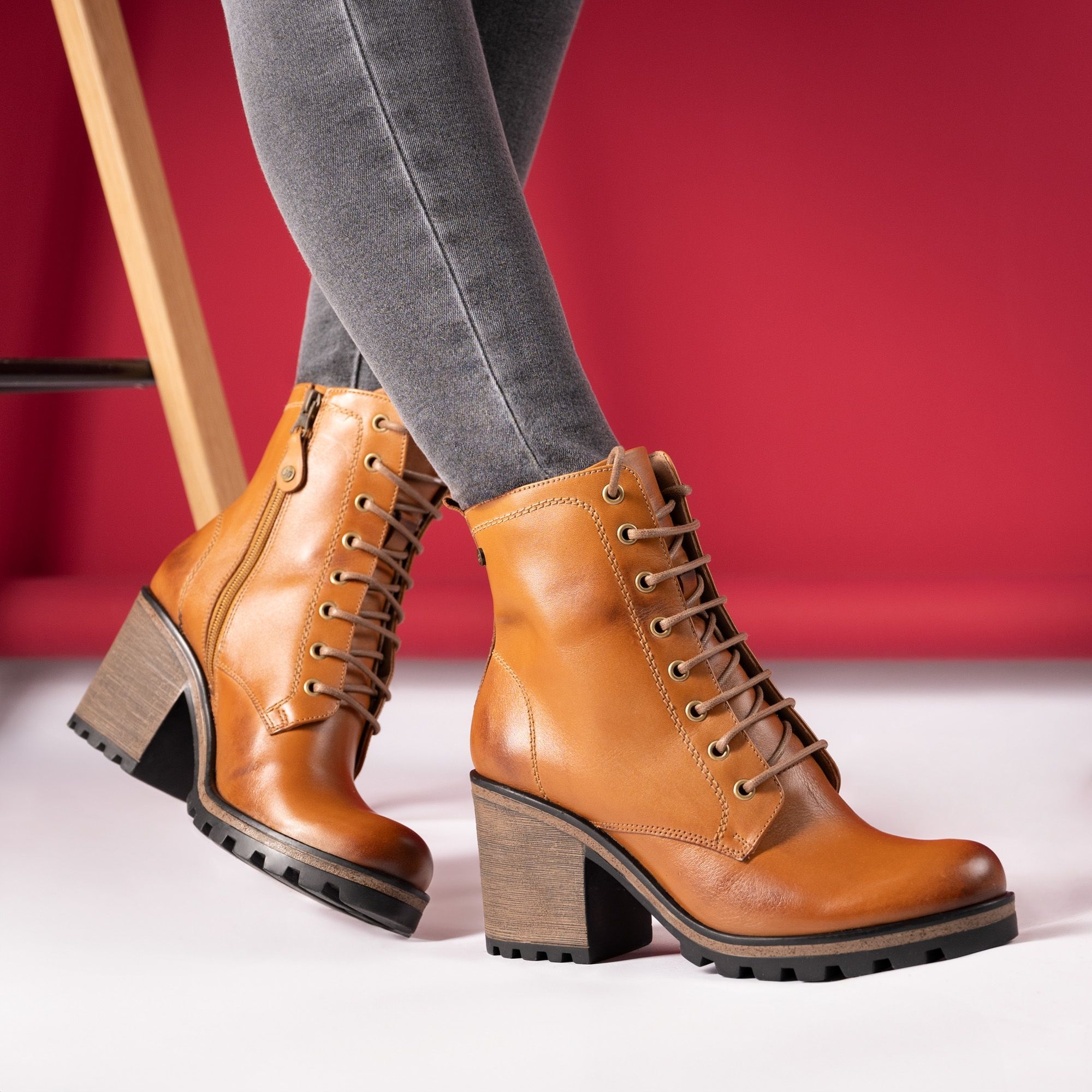 Fashionable brown ankle boots paired with grey jeans, perfect for a chic look.