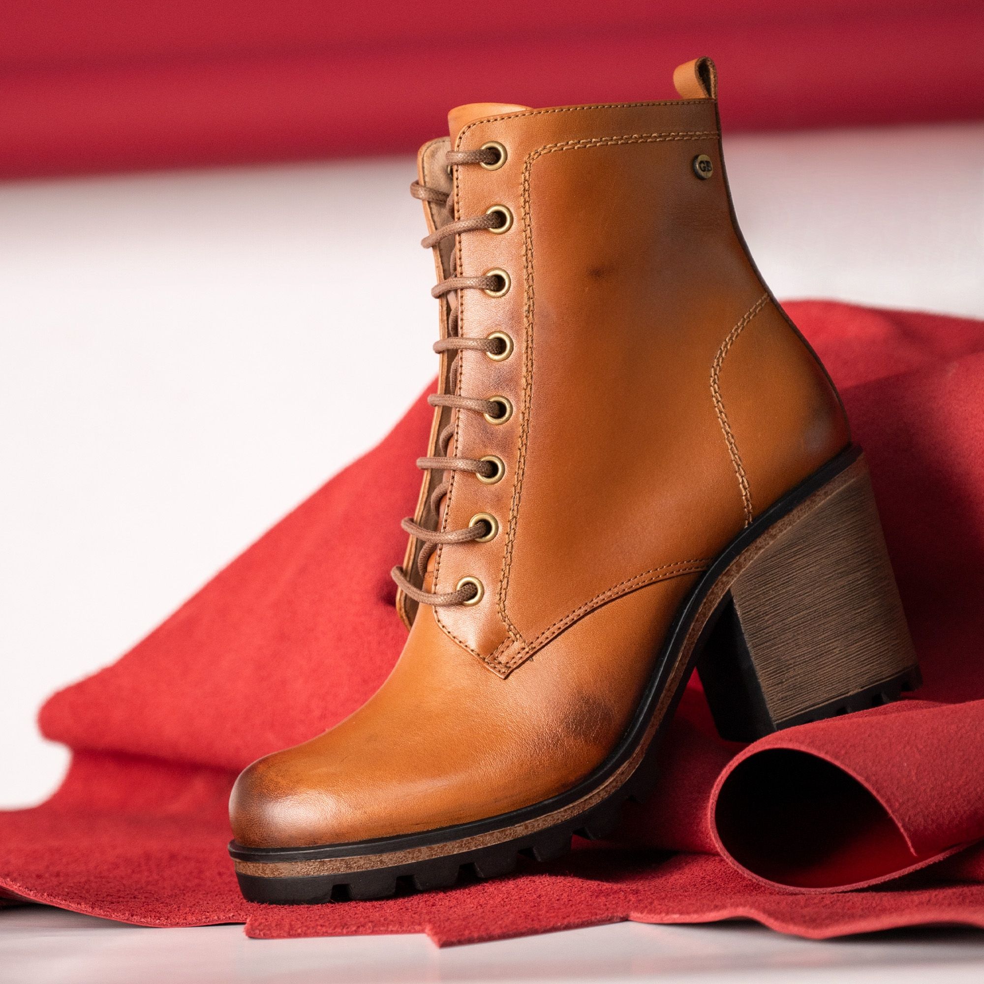 Stylish tan leather ankle boot with block heel, perfect for autumn fashion.