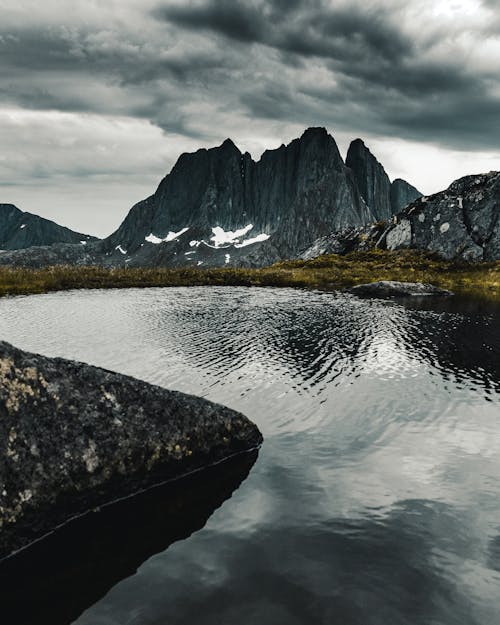 Body of Water Under Cloudy Sky