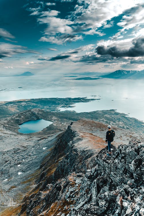 Person Standing on Rock