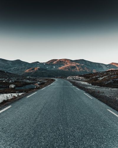 Empty mountain road at twilight — photo by Tobias Bjørkli on Pexels