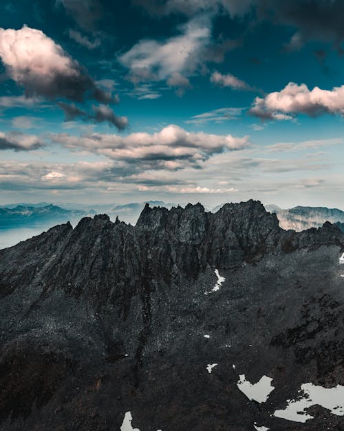 Mountainous terrain with high peaks under blue sky