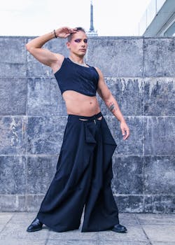 A bold urban fashion portrait featuring a stylish model in contemporary attire against a concrete backdrop.