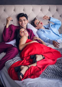 Fashionable group relaxing with artistic makeup in a chic indoor setting.