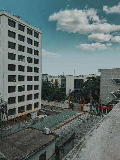 Free Sky view of Dhaka city showcasing urban buildings and clear skies with city life. Stock Photo