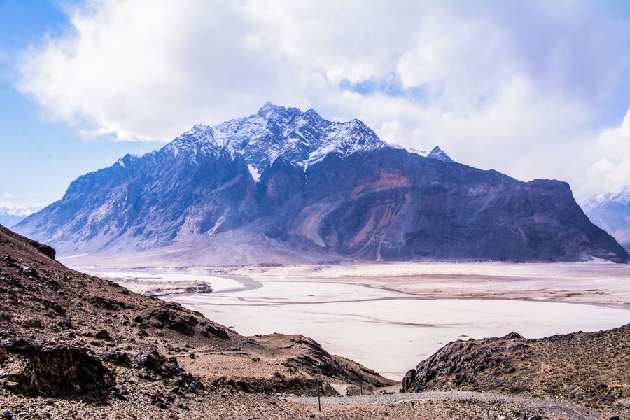 Snow-capped mountain above the sandy plain of the Skardu valley