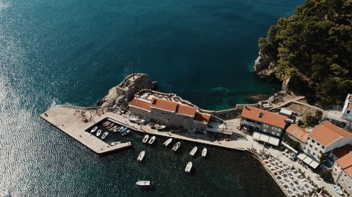 Free A stunning aerial view of Petrovac harbor with boats and historic architecture, captured on a sunny day. Stock Photo