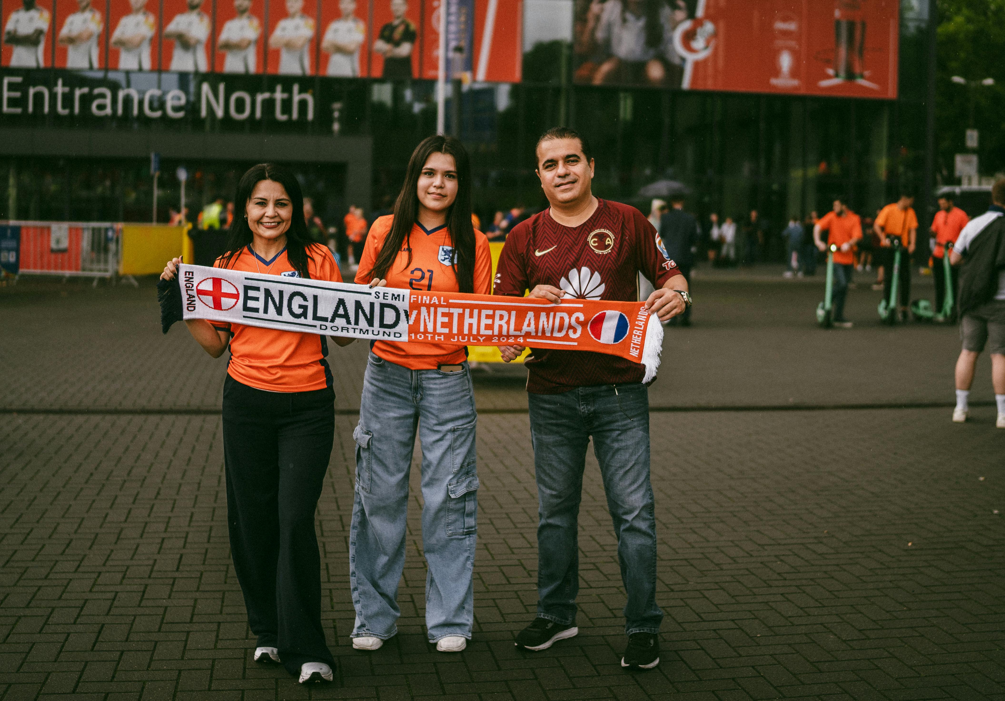 family of soccer fans posing in front of bvb stadion dortmund