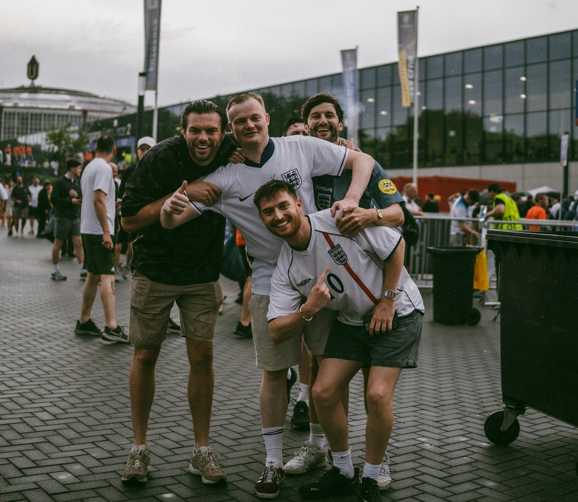 Smiling Men Posing in England Soccer Jerseys