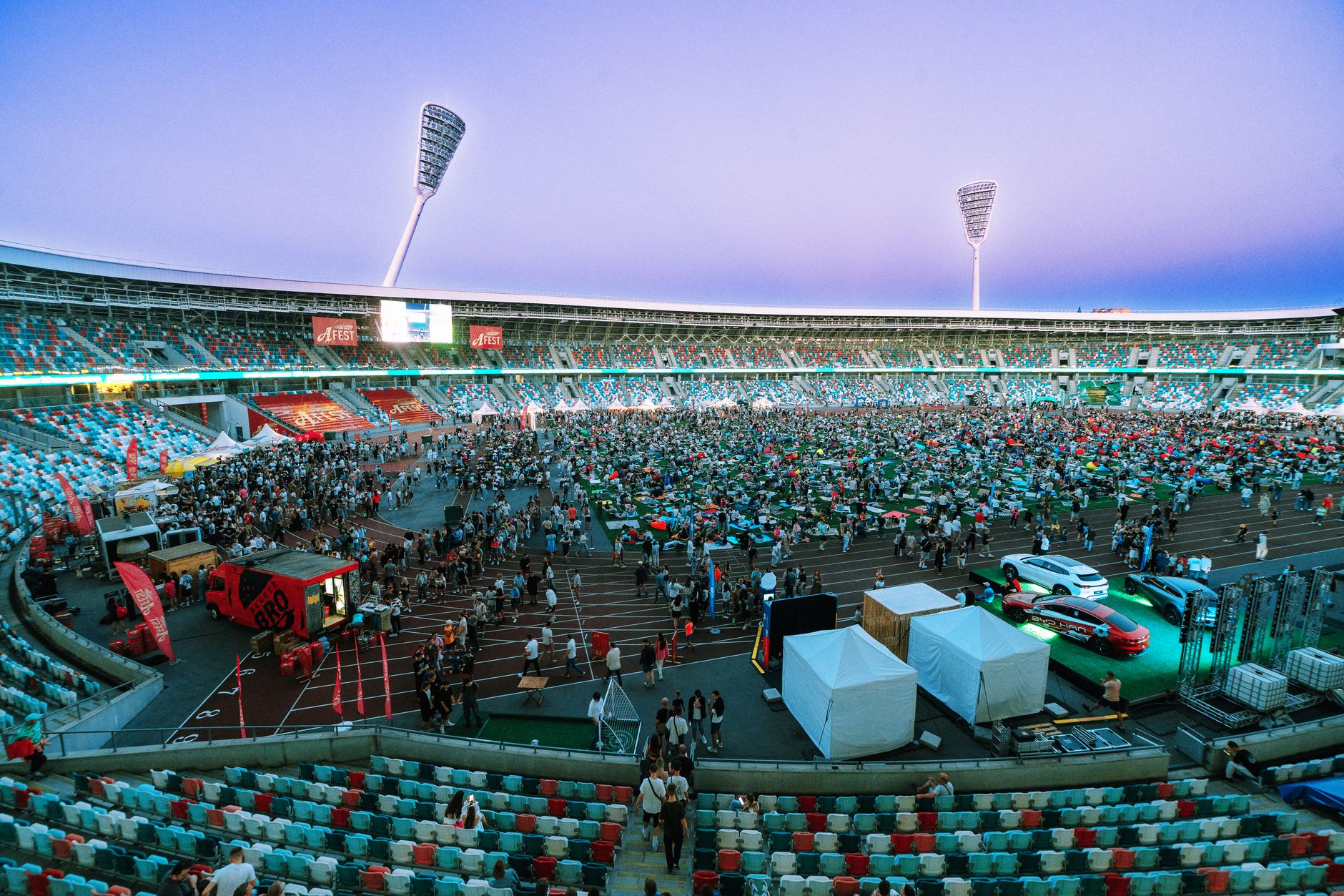 Aerial view of a large crowd gathering in a stadium during twilight. Perfect for event and sports th