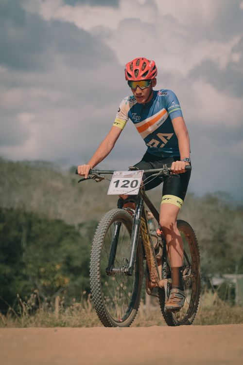 Free Adult mountain biker competing outdoors on a dirt trail, showcasing fitness and sport. Stock Photo